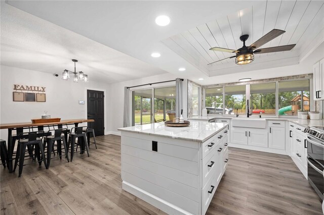 2255 61st St, Sarasota, FL 34243 - kitchen featuring a sink, plenty of natural light, a center island, light wood-type flooring, and recessed lighting