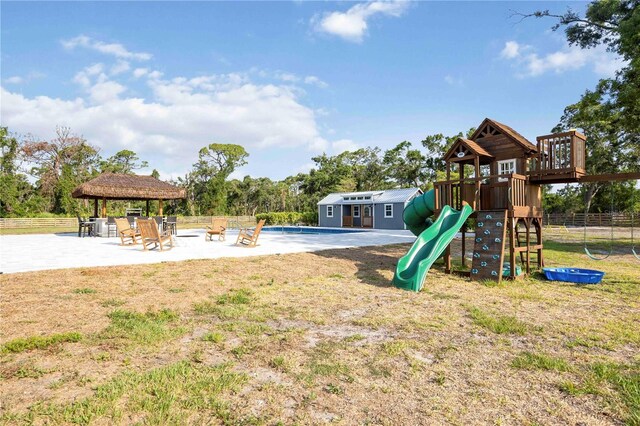 2255 61st St, Sarasota, FL 34243 - community play area with a gazebo, a patio, and view of wooded area