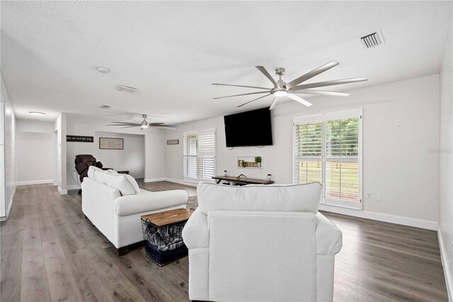 2255 61st St, Sarasota, FL 34243 - living area featuring ceiling fan, healthy amount of natural light, wood finished floors, and baseboards
