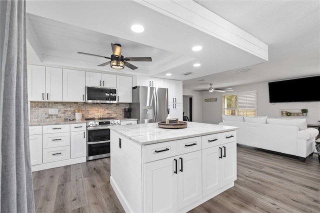2255 61st St, Sarasota, FL 34243 - kitchen with stainless steel appliances, ceiling fan, light wood-type flooring, backsplash, and recessed lighting