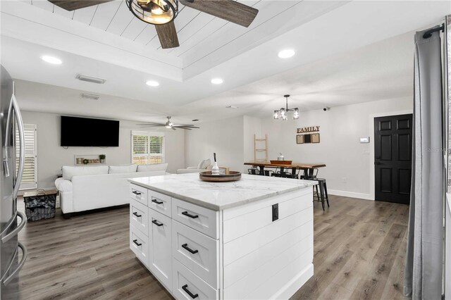 2255 61st St, Sarasota, FL 34243 - kitchen with a ceiling fan, wood finished floors, white cabinets, open floor plan, and recessed lighting