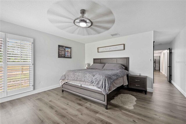 2255 61st St, Sarasota, FL 34243 - bedroom with wood finished floors, baseboards, and ceiling fan