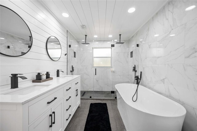 2255 61st St, Sarasota, FL 34243 - bathroom featuring a marble finish shower, a freestanding bath, double vanity, recessed lighting, and tile walls