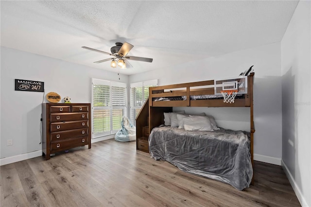 2255 61st St, Sarasota, FL 34243 - bedroom featuring wood finished floors, baseboards, a ceiling fan, and a textured ceiling