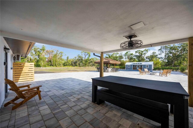 2255 61st St, Sarasota, FL 34243 - view of patio with a covered hot tub, an outbuilding, and ceiling fan