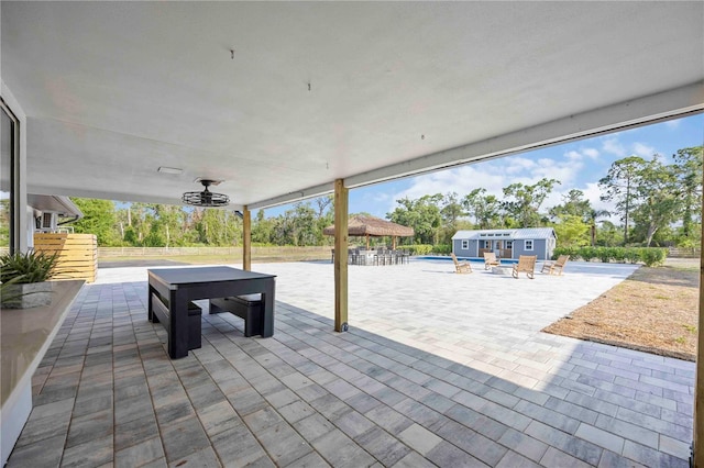 2255 61st St, Sarasota, FL 34243 - view of patio with an outbuilding, an outdoor pool, a hot tub, a gazebo, and a storage structure