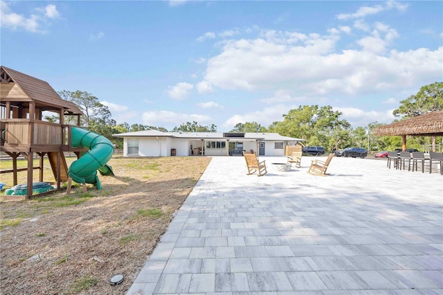 2255 61st St, Sarasota, FL 34243 - back of house featuring a patio area, a playground, and metal roof