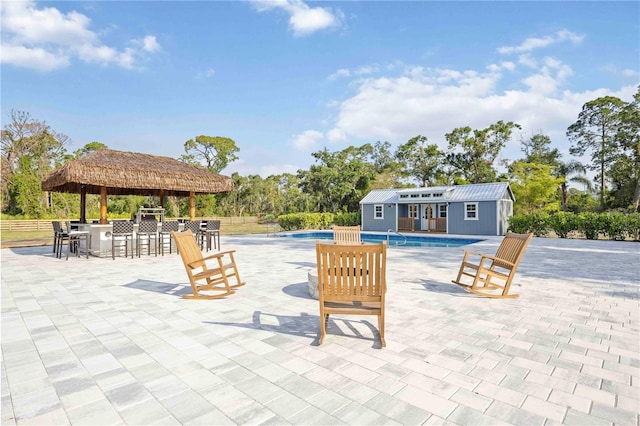 2255 61st St, Sarasota, FL 34243 - outdoor pool with an outdoor structure, a patio area, and an exterior structure