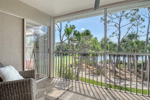 9540 High Gate Dr Unit 1422, Sarasota, FL 34238 - sunroom featuring a textured wall and a water view