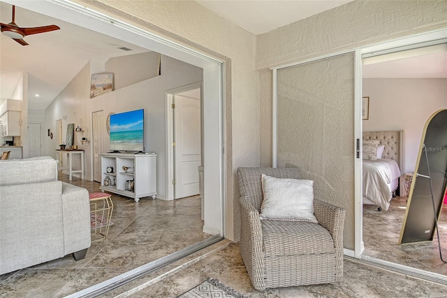 9540 High Gate Dr Unit 1422, Sarasota, FL 34238 - living area with a ceiling fan, a textured wall, and lofted ceiling