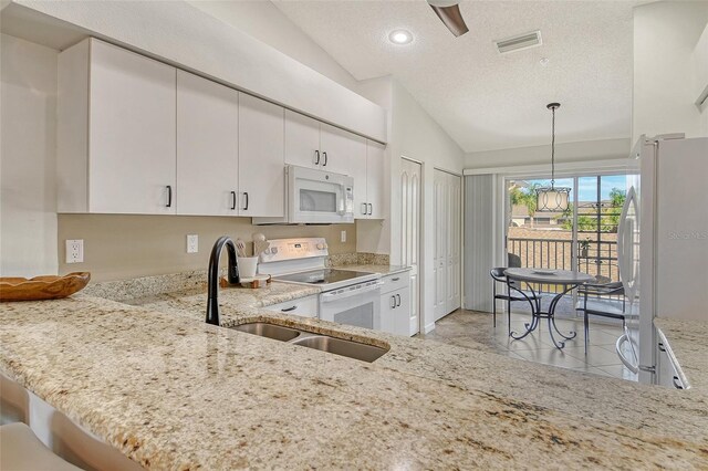 9540 High Gate Dr Unit 1422, Sarasota, FL 34238 - kitchen featuring white appliances, lofted ceiling, a textured ceiling, light stone counters, and a chandelier