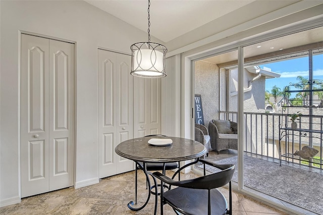 9540 High Gate Dr Unit 1422, Sarasota, FL 34238 - dining room with lofted ceiling and baseboards