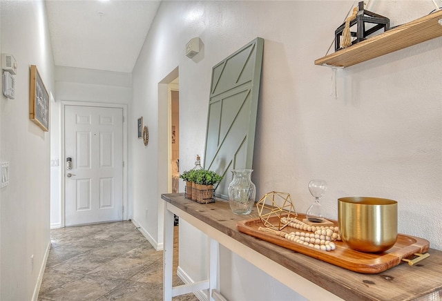 9540 High Gate Dr Unit 1422, Sarasota, FL 34238 - corridor featuring baseboards and light stone finish flooring