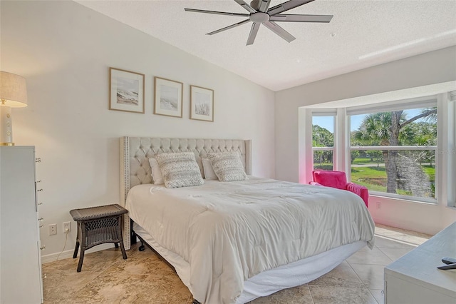 9540 High Gate Dr Unit 1422, Sarasota, FL 34238 - bedroom with a textured ceiling, a ceiling fan, light tile patterned floors, baseboards, and vaulted ceiling