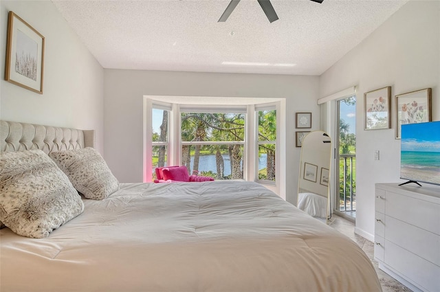 9540 High Gate Dr Unit 1422, Sarasota, FL 34238 - bedroom with access to exterior, a textured ceiling, and ceiling fan