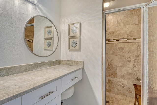 9540 High Gate Dr Unit 1422, Sarasota, FL 34238 - full bathroom featuring vanity, a shower stall, and a textured wall