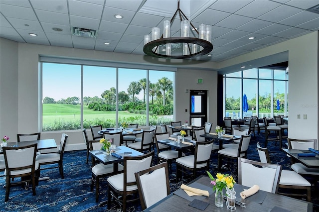 9540 High Gate Dr Unit 1422, Sarasota, FL 34238 - carpeted dining area featuring golf course view, a paneled ceiling, baseboards, and recessed lighting