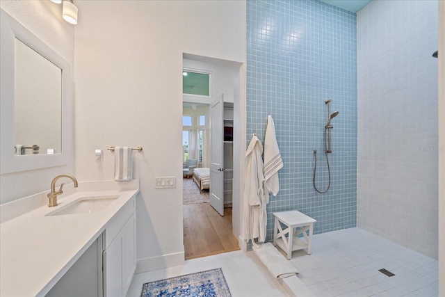 7507 Ascot Ct, University Park, FL 34201 - ensuite bathroom with vanity, tiled shower, and wood finished floors