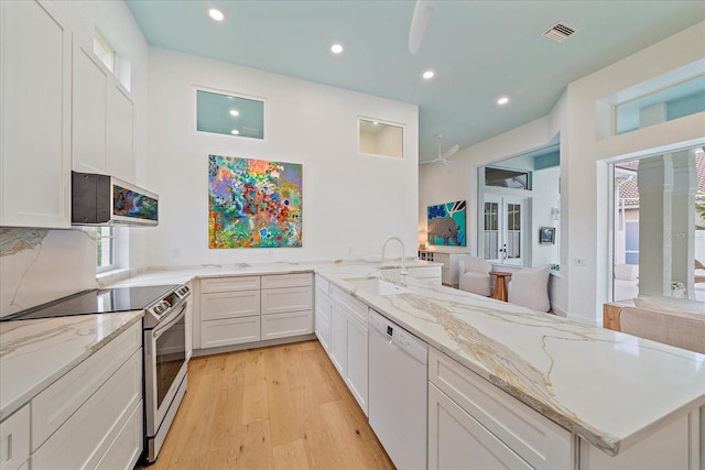 7507 Ascot Ct, University Park, FL 34201 - kitchen featuring dishwasher, electric range, recessed lighting, light wood-type flooring, and ceiling fan