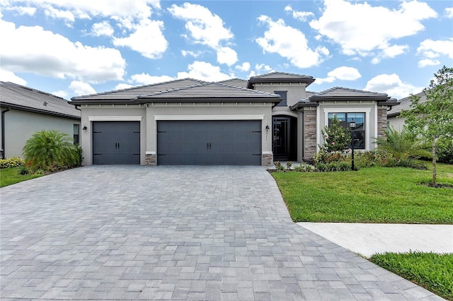 4971 Oyster Pearl St, Bradenton, FL 34211 - prairie-style house featuring decorative driveway, stone siding, a garage, and stucco siding