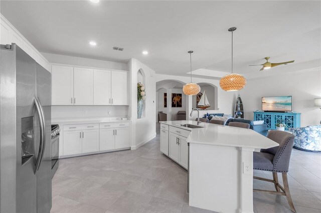 4971 Oyster Pearl St, Bradenton, FL 34211 - kitchen with stainless steel fridge, a sink, open floor plan, arched walkways, and light countertops