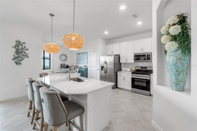4971 Oyster Pearl St, Bradenton, FL 34211 - kitchen with appliances with stainless steel finishes, a sink, a breakfast bar, white cabinets, and recessed lighting