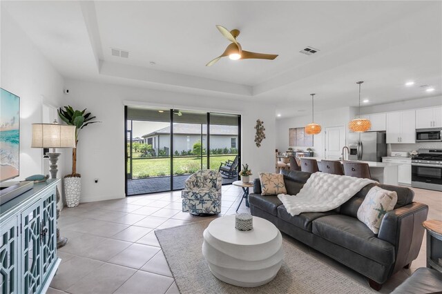 4971 Oyster Pearl St, Bradenton, FL 34211 - living area with a raised ceiling, a ceiling fan, light tile patterned floors, recessed lighting, and baseboards