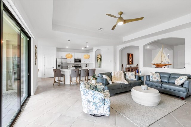 4971 Oyster Pearl St, Bradenton, FL 34211 - living area featuring light tile patterned flooring, a raised ceiling, a ceiling fan, and recessed lighting