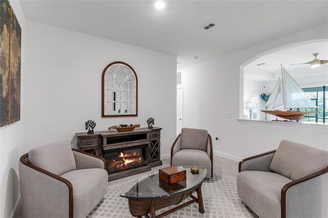4971 Oyster Pearl St, Bradenton, FL 34211 - living room featuring arched walkways, baseboards, a glass covered fireplace, and recessed lighting