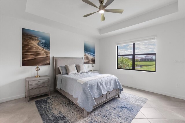 4971 Oyster Pearl St, Bradenton, FL 34211 - bedroom featuring a tray ceiling, light tile patterned flooring, baseboards, and a ceiling fan