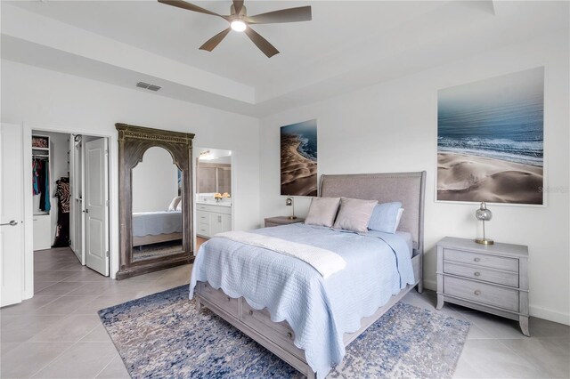 4971 Oyster Pearl St, Bradenton, FL 34211 - bedroom with light tile patterned floors, a tray ceiling, ensuite bath, and a ceiling fan