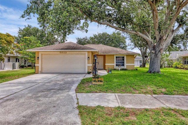 5823 Helen Way, Sarasota, FL 34243 - ranch-style home with stucco siding, an attached garage, concrete driveway, and a front yard