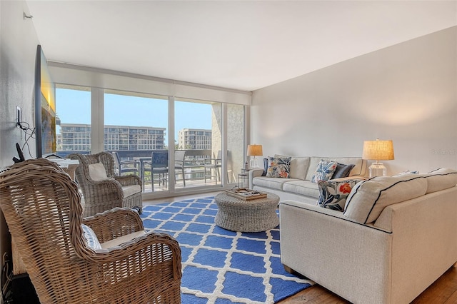 1115 Gulf Of Mexico Dr Unit 304, Longboat Key, FL 34228 - living room with healthy amount of natural light and wood finished floors