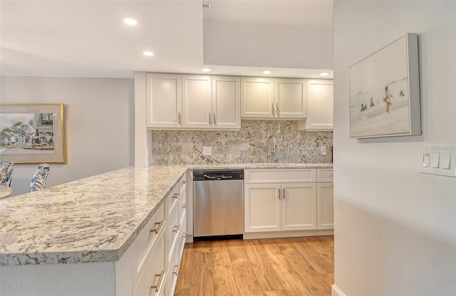 1115 Gulf Of Mexico Dr Unit 304, Longboat Key, FL 34228 - kitchen with dishwasher, a sink, recessed lighting, light wood finished floors, and decorative backsplash