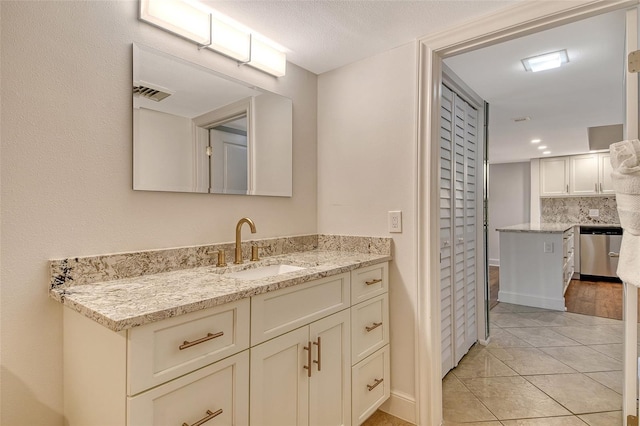 1115 Gulf Of Mexico Dr Unit 304, Longboat Key, FL 34228 - bathroom featuring vanity, tasteful backsplash, and tile patterned flooring