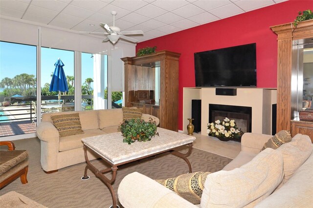 1115 Gulf Of Mexico Dr Unit 304, Longboat Key, FL 34228 - living room featuring ceiling fan and a fireplace