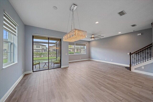 5191 78th St Cir E, Bradenton, FL 34203 - unfurnished living room featuring a ceiling fan, light wood-style flooring, baseboards, stairway, and recessed lighting