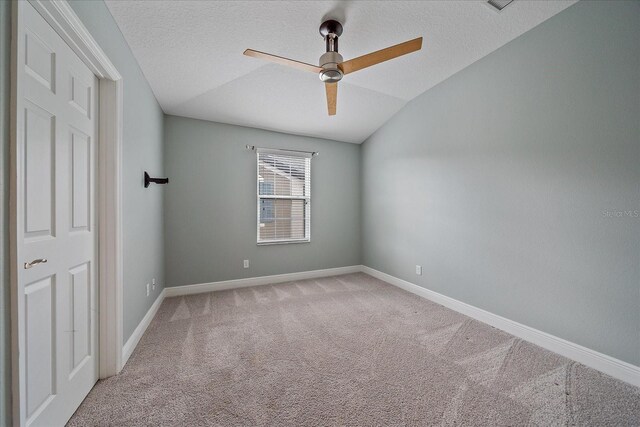 5191 78th St Cir E, Bradenton, FL 34203 - unfurnished bedroom featuring light carpet, vaulted ceiling, baseboards, a textured ceiling, and a ceiling fan