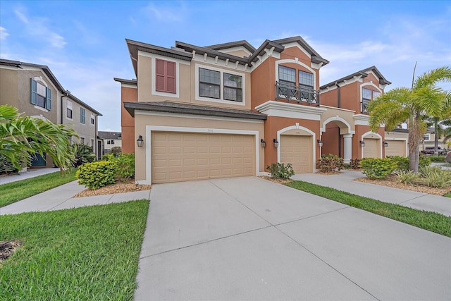 5191 78th St Cir E, Bradenton, FL 34203 - view of front facade with an attached garage, driveway, stucco siding, and a balcony
