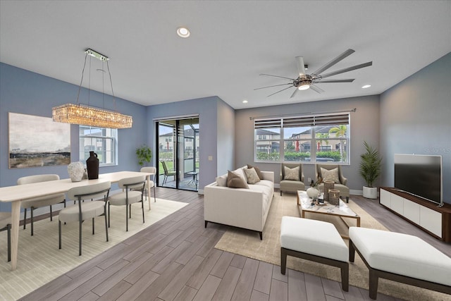 5191 78th St Cir E, Bradenton, FL 34203 - living room featuring healthy amount of natural light, wood finished floors, a ceiling fan, recessed lighting, and baseboards