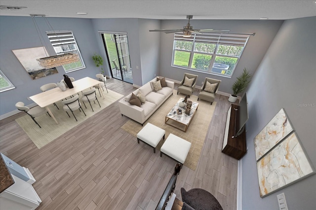 5191 78th St Cir E, Bradenton, FL 34203 - living room featuring wood finished floors, ceiling fan, and baseboards