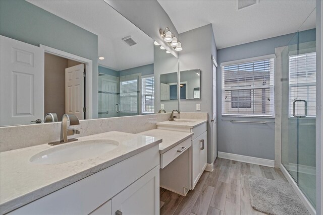5191 78th St Cir E, Bradenton, FL 34203 - full bath with double vanity, a shower stall, baseboards, and wood finished floors