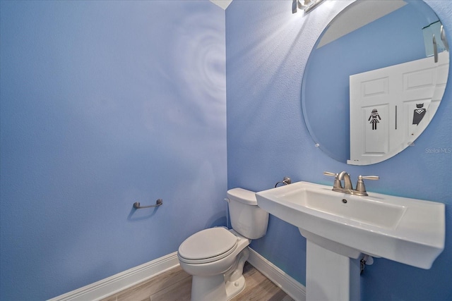 5191 78th St Cir E, Bradenton, FL 34203 - bathroom featuring wood finished floors, toilet, baseboards, and a sink