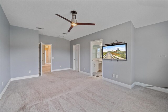 5191 78th St Cir E, Bradenton, FL 34203 - unfurnished bedroom featuring light colored carpet, baseboards, ensuite bathroom, and a ceiling fan