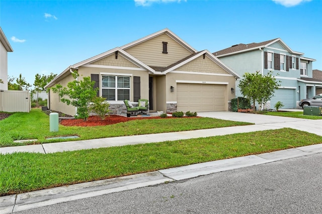 5659 Woodland Sage Dr, Sarasota, FL 34238 - view of front of house with concrete driveway, a garage, stucco siding, and stone siding