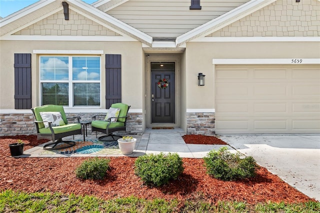 5659 Woodland Sage Dr, Sarasota, FL 34238 - view of exterior entry featuring stone siding, an attached garage, stucco siding, concrete driveway, and covered porch