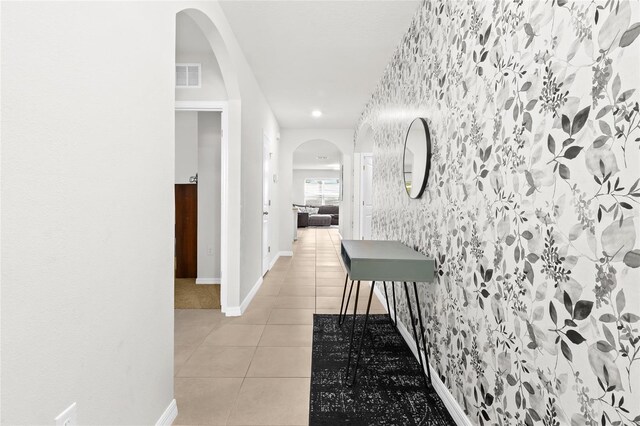 5659 Woodland Sage Dr, Sarasota, FL 34238 - corridor with arched walkways, light tile patterned floors, baseboards, and recessed lighting