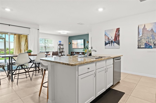 5659 Woodland Sage Dr, Sarasota, FL 34238 - kitchen with dishwasher, a sink, light tile patterned flooring, a center island, and white cabinets