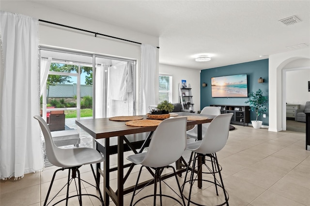 5659 Woodland Sage Dr, Sarasota, FL 34238 - dining room with light tile patterned floors, healthy amount of natural light, and arched walkways