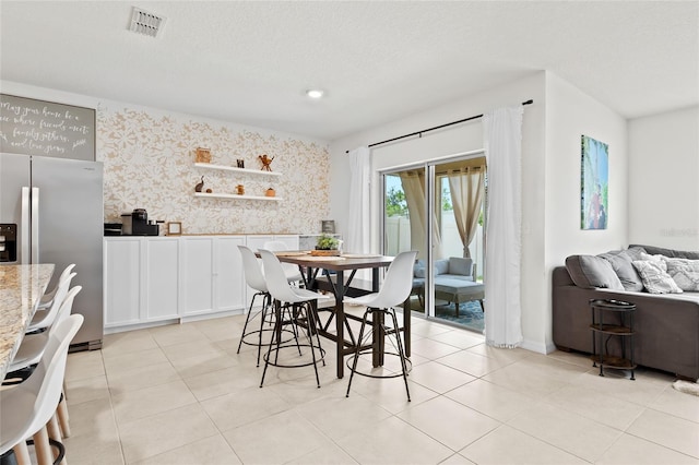 5659 Woodland Sage Dr, Sarasota, FL 34238 - dining room featuring wallpapered walls, a wainscoted wall, and light tile patterned floors